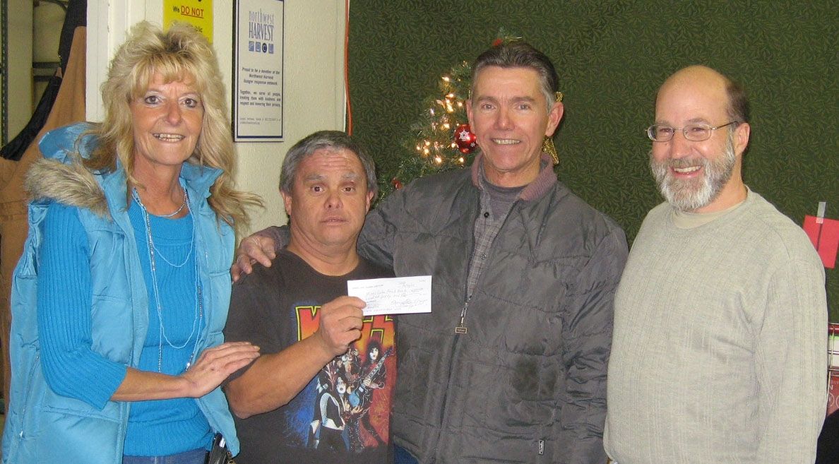 Penny Archer, Scott Kilpatrick and Benny of the Moses Lake Food Bank accept check in 2010